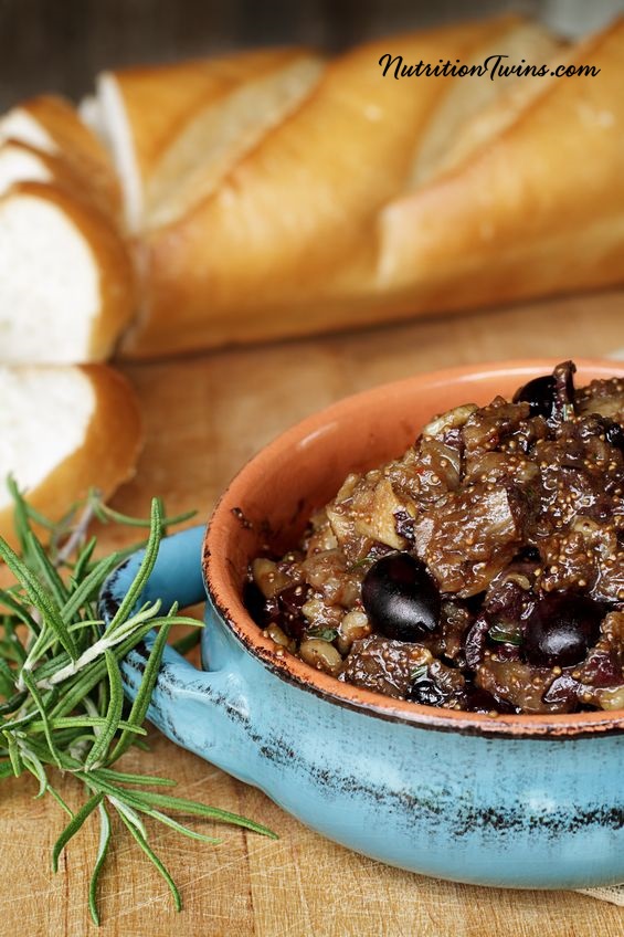 20460852 - fig tapenade prepared with figs, kalamata olives and fresh herbs.