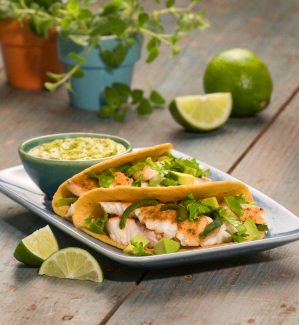fish tacos in pumpkin seed chipotle sauce with pan-fried avocado