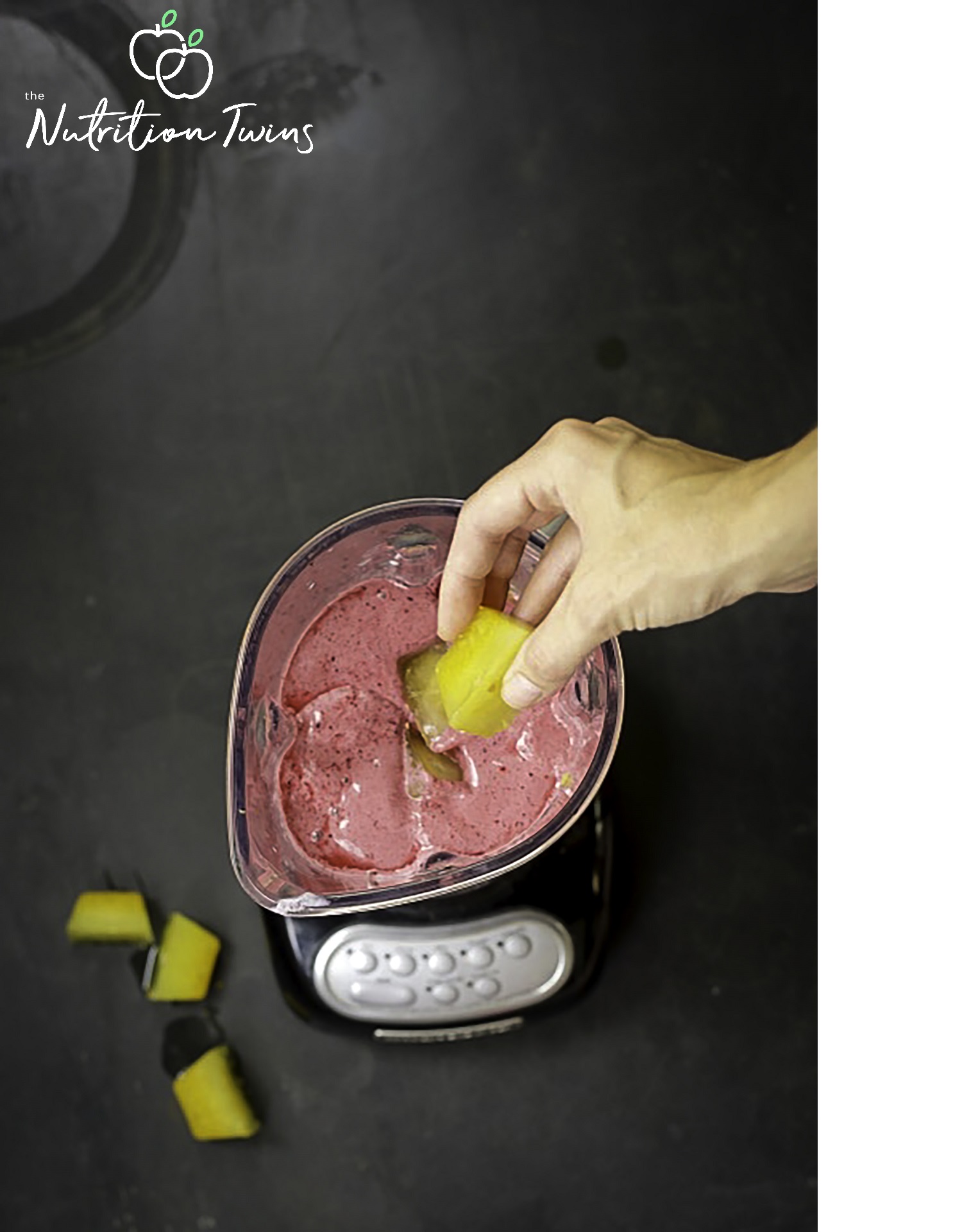 ginger turmeric ice cube with hand overhead view of berry smoothie
